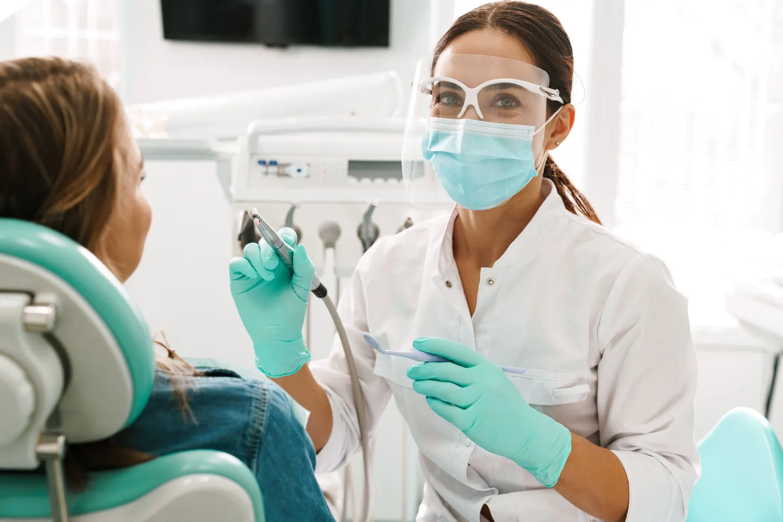 Friendly dental team member with a patient